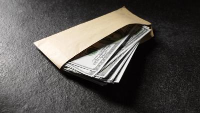 American dollars in an envelope on a dark background