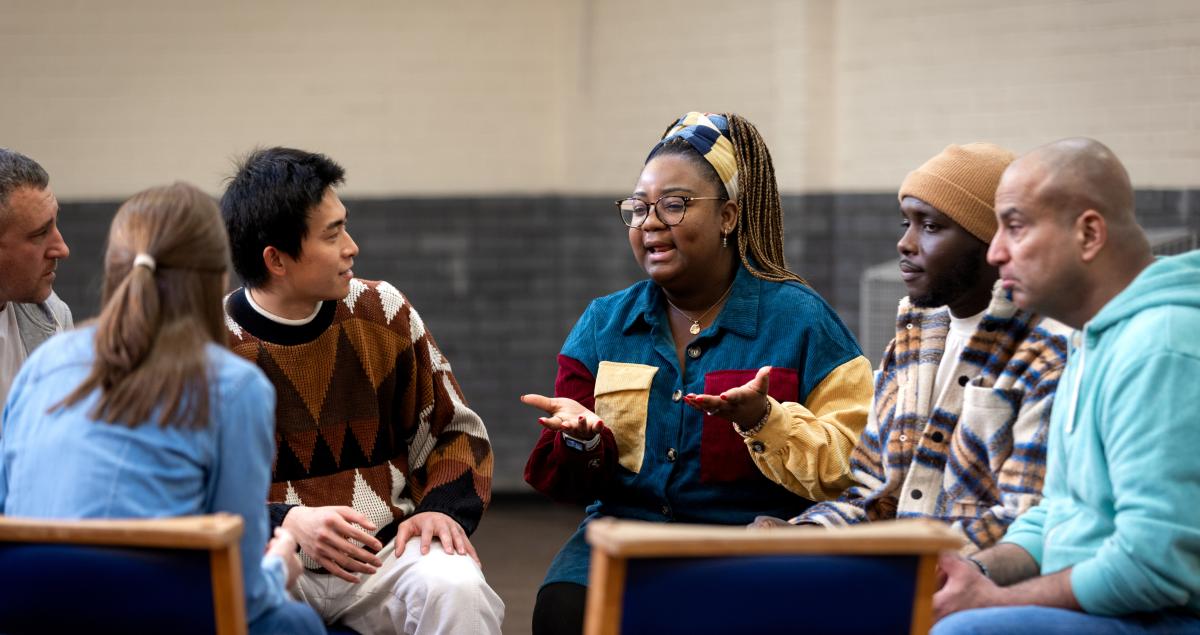 A group of people sitting together having a conversation