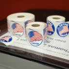 Rolls of stickers that say "I Voted" and have American flags on them.