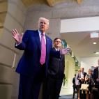 President Trump and Mike Johnson standing in front of a line or reporters with cameras