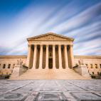 The front of the U.S. Supreme Court building with clouds behind it