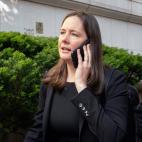 Maurene Comey walking outside while talking on a phone