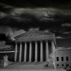 A black and white photo of the Supreme Court building on a stormy day