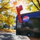A mailbox with its flag raised and a sticker on it saying "I Voted Today!"