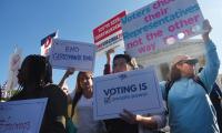 Protesters hold signs for fair maps at the U.S. Supreme Court 