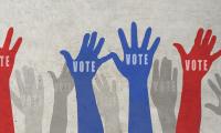 blue, red and gray hands raised to vote