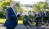 President Donald Trump speaking to the press in front of the White House