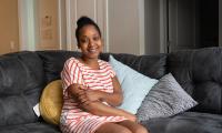 Jawharrah Bahar sitting on her couch 