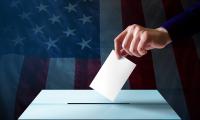 Person casting their vote into a ballot box