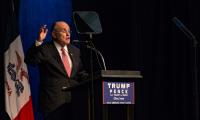 Rudy Giuliani speaking at a podium