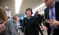 Susan Collins with reporters around her