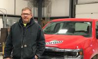 Leroy Pingel standing in front of a pickup truck with a Cargill logo on it