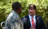 Steven Palazzo speaking to a man in military fatigues