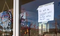A sign in a window of a cafe reads "We will be closed until further notice. Stay well!"