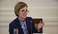 Kim Reynolds wearing glasses and speaking white seated at a desk