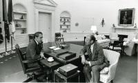 Nixon and Ford sitting across the desk from each other in the Oval Office.