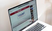 A laptop screen showing a Trump campaign ad on YouTube