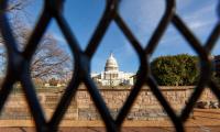 The U.S. Capitol building seen through fencing