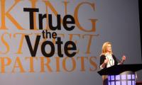Catherine Engelbrecht speaking at a podium with a "True the Vote" sign behind her