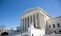 The Supreme Court building against a blue sky on a sunny day