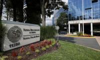 The National Rifle Association sign and logo outside a large glass building.