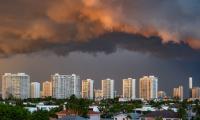 A view of apartment buildings in Florida with dark clouds overhead.