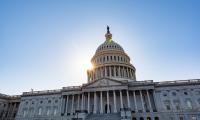 The dome of the U.S. Capitol Building with a sunburst appearing behind it