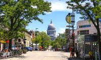 The Wisconsin state capitol building seen along a downtown street