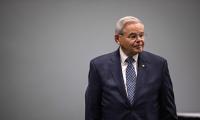 Bob Menendez standing in front of a gray wall