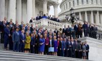 Members of the 118th Congress posing for a photo on the steps of the U.S. Capitol Building.
