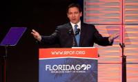 Ron DeSantis speaking at a podium