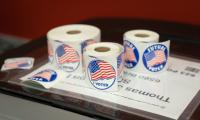 Rolls of stickers that say "I Voted" and have American flags on them.