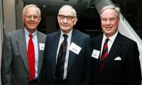 Three men in suits posing for the camera