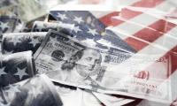 $100 bills on top of the American flag
