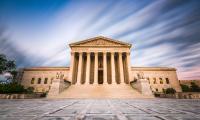 The front of the U.S. Supreme Court building with clouds behind it