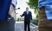 Tom Homan in front of the White House talking to press with microphones