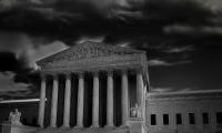 A black and white photo of the Supreme Court building on a stormy day