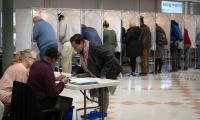 Voters at a polling place checking in and casting ballots.