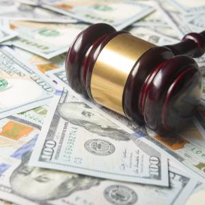 A gavel on top of a pile of money