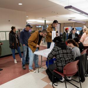 People line up in a school cafeteria