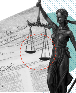 Blindfolded Lady Justice holds scales over U.S. historical documents, including the Declaration of Independence and Constitution, symbolizing law and fairness.