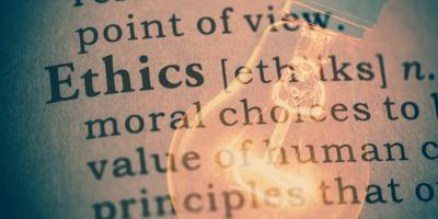 Lightbulb overlaid on definition of "ethics"
