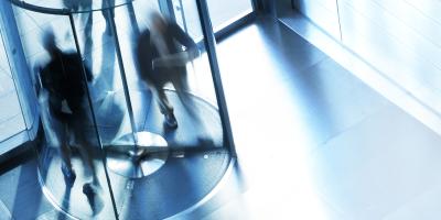 People going through a revolving door.