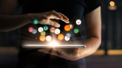 person using tablet with digital marketing icons