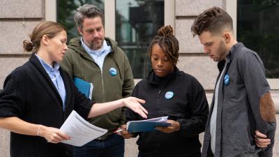 A group of people looking at a clipboard