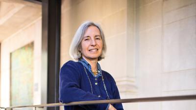 Martha Minow leaning on a railing