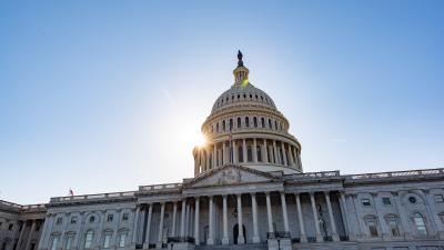 The dome of the U.S. Capitol Building with a sunburst appearing behind it
