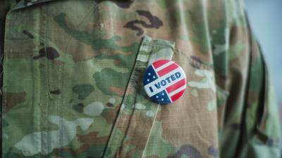 Close up of a person in fatigues with an "I Voted" pin
