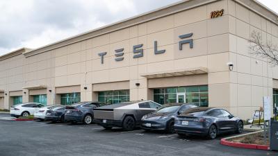 Exterior entrance of a Tesla Service and repair center with cybertruck.
