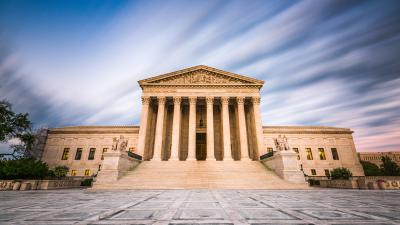 The front of the U.S. Supreme Court building with clouds behind it